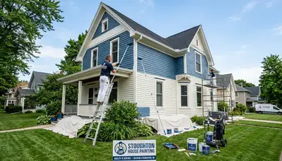 Professional house painters in Madison WI applying exterior paint to residential home