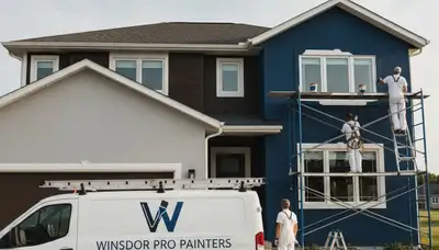 Professional house painters working on residential exterior in Madison WI